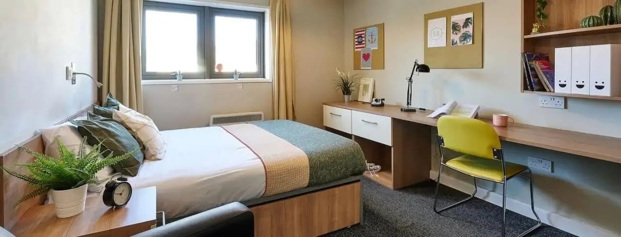 Bed desk and chair student accommodation bedroom at Exeter Trust House in Exeter Student Accommodation