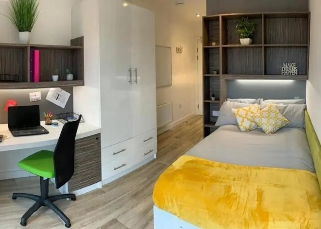 Desk laptop green chair white wardrobe bedroom at Newcastle 1 in Newcastle Upon Tyne Student Accommodation
