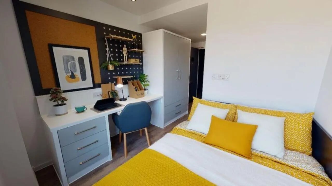 Desk bed wardrobe and chair bedroom at iQ Bloomsbury in London Student Accommodation
