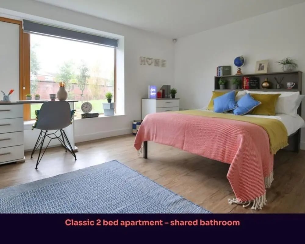 Bed desk chair window blue rug bedroom at Victoria Point in Manchester Student Accommodation