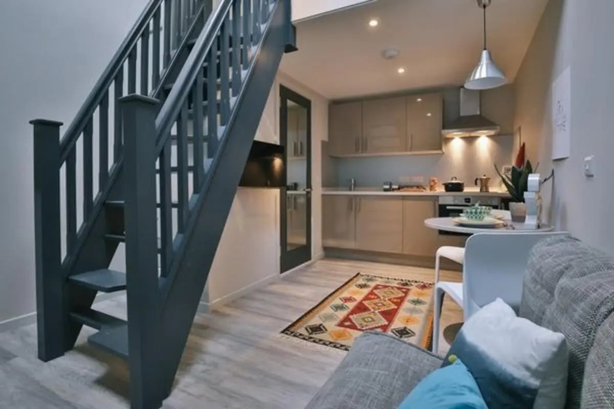 Stairs kitchen table sofa living area at Dean Clarke Lofts in Exeter Student Accommodation