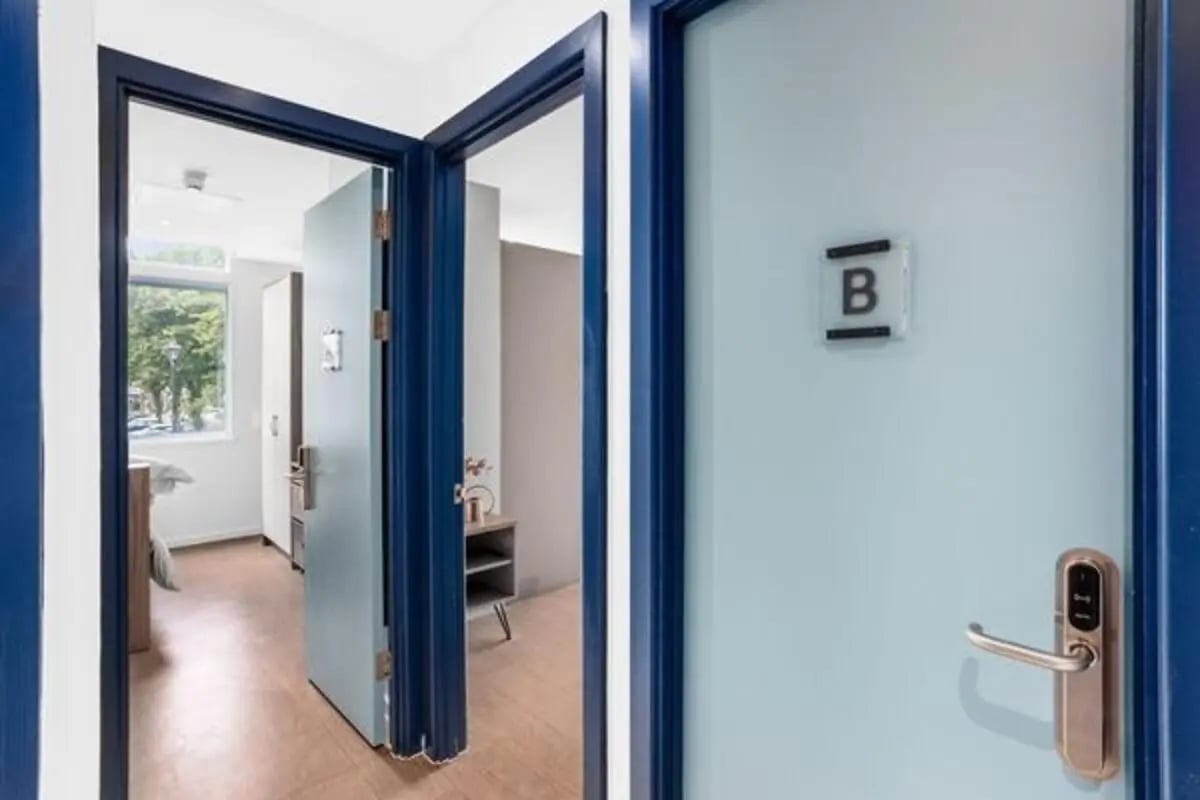 Doorway to bedroom with bed and closet bedroom at Algernon Firth in Leeds Student Accommodation