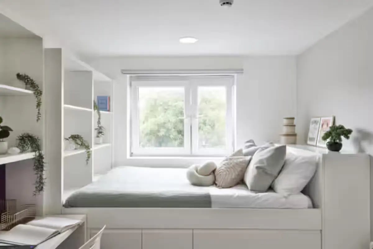 Bed with pillows and shelves Bedroom at Picturehouse Apartments in Exeter Student Accommodation