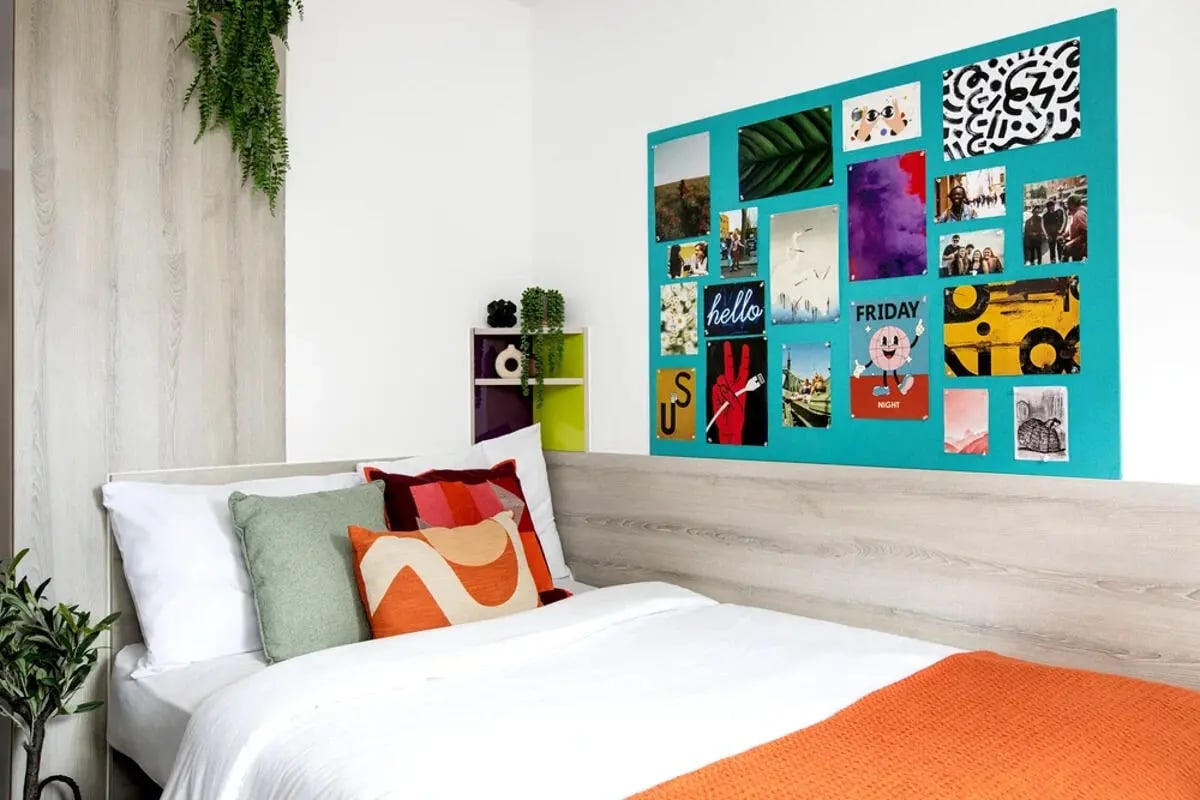 Bed with colorful pillows and collage wall Bedroom at Mercury Point in Southampton Student Accommodation