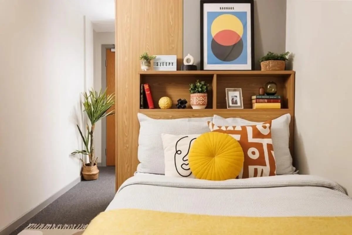 Bed with pillows artwork plant bedroom at Manor Bank in Newcastle Upon Tyne Student Accommodation