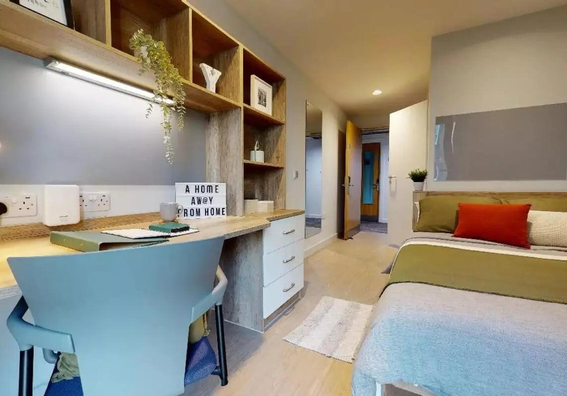 Desk bed shelves and open door bedroom at iQ Elgin Place in Glasgow Student Accommodation