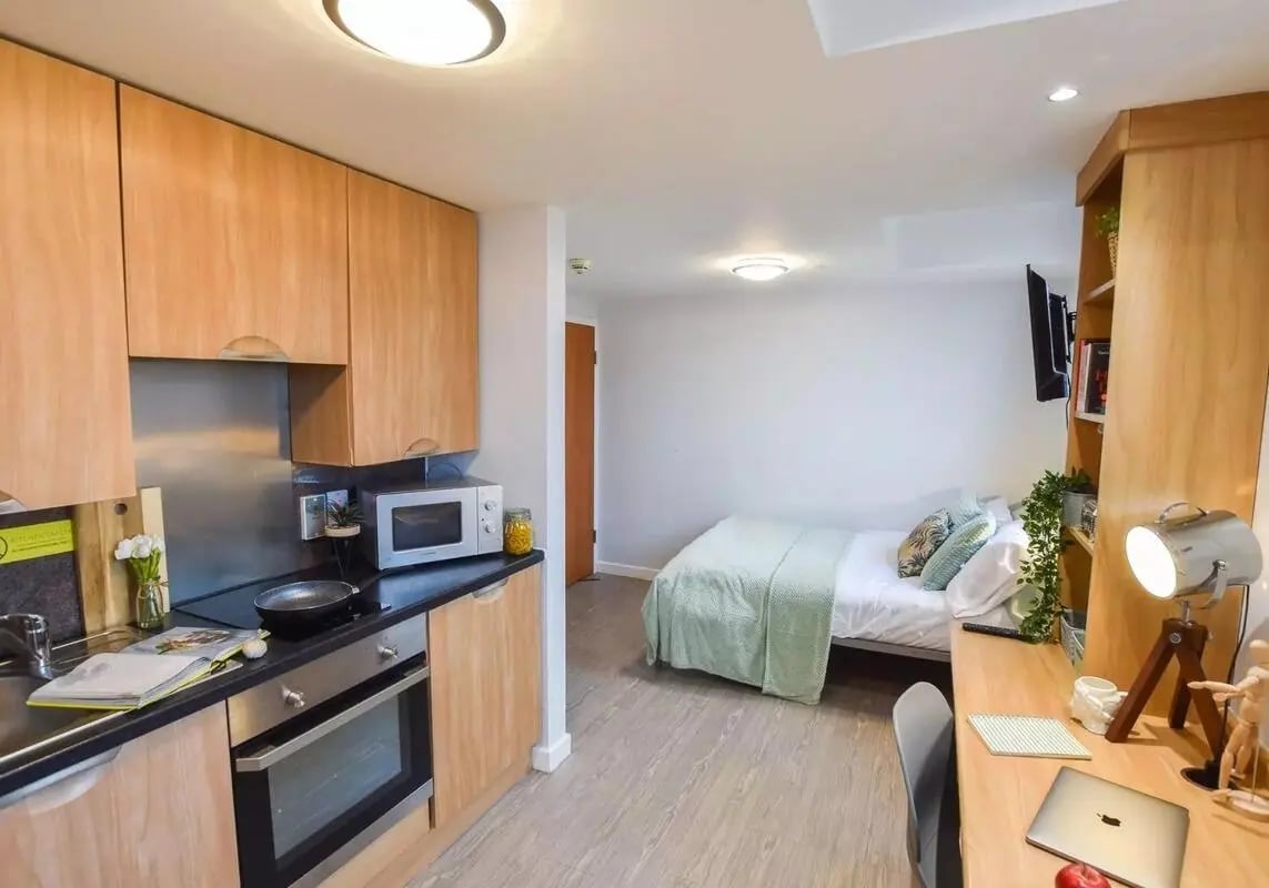 Kitchenette and bed with desk Living room at iQ Steel in Sheffield Student Accommodation