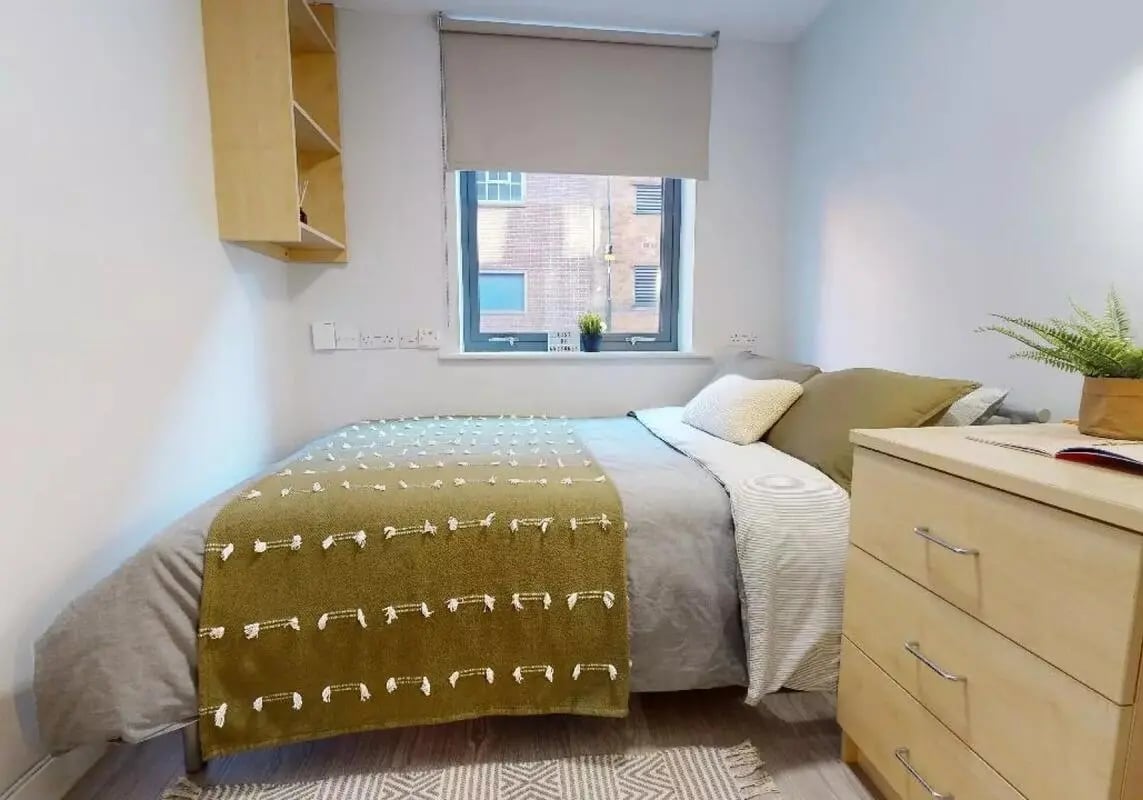 Bed with green throw and dresser bedroom at iQ Brocco in Sheffield Student Accommodation