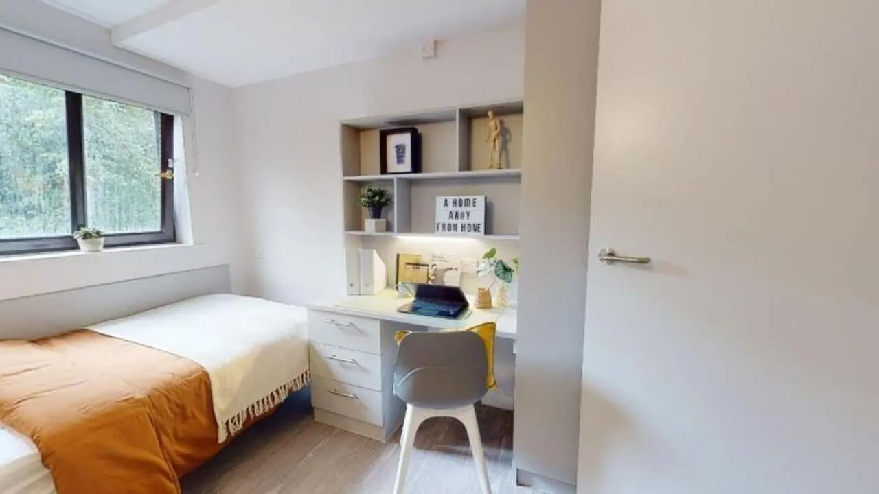 Bed desk with laptop and chair bedroom at iQ Manchester Gardens in Manchester Student Accommodation