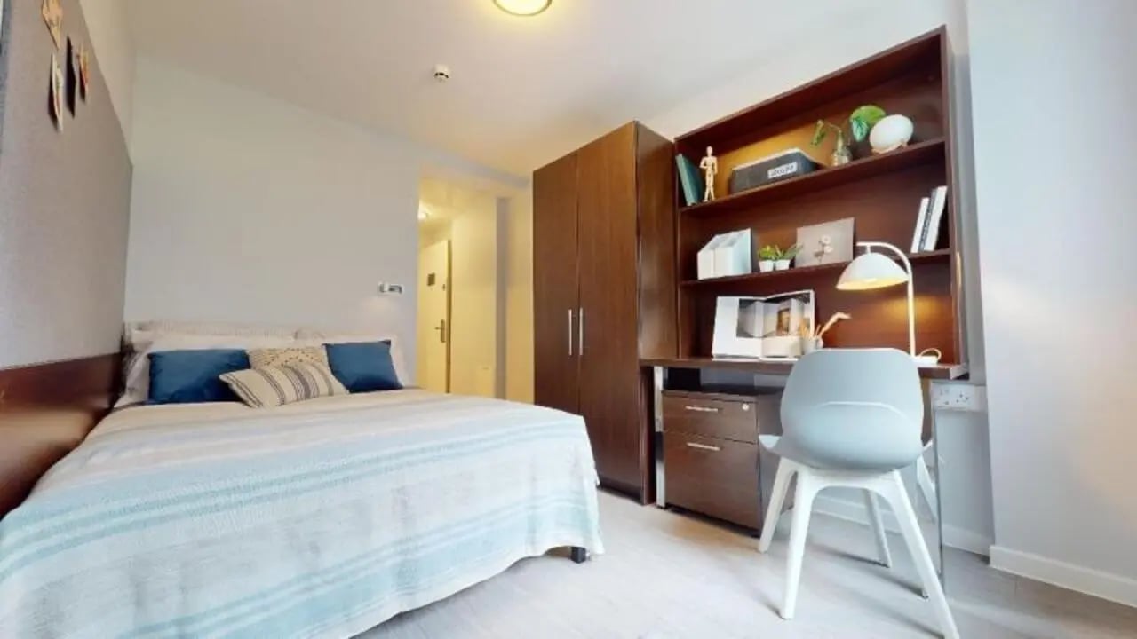 Bed wardrobe desk chair lamp bedroom study area at iQ Highbury in London Student Accommodation