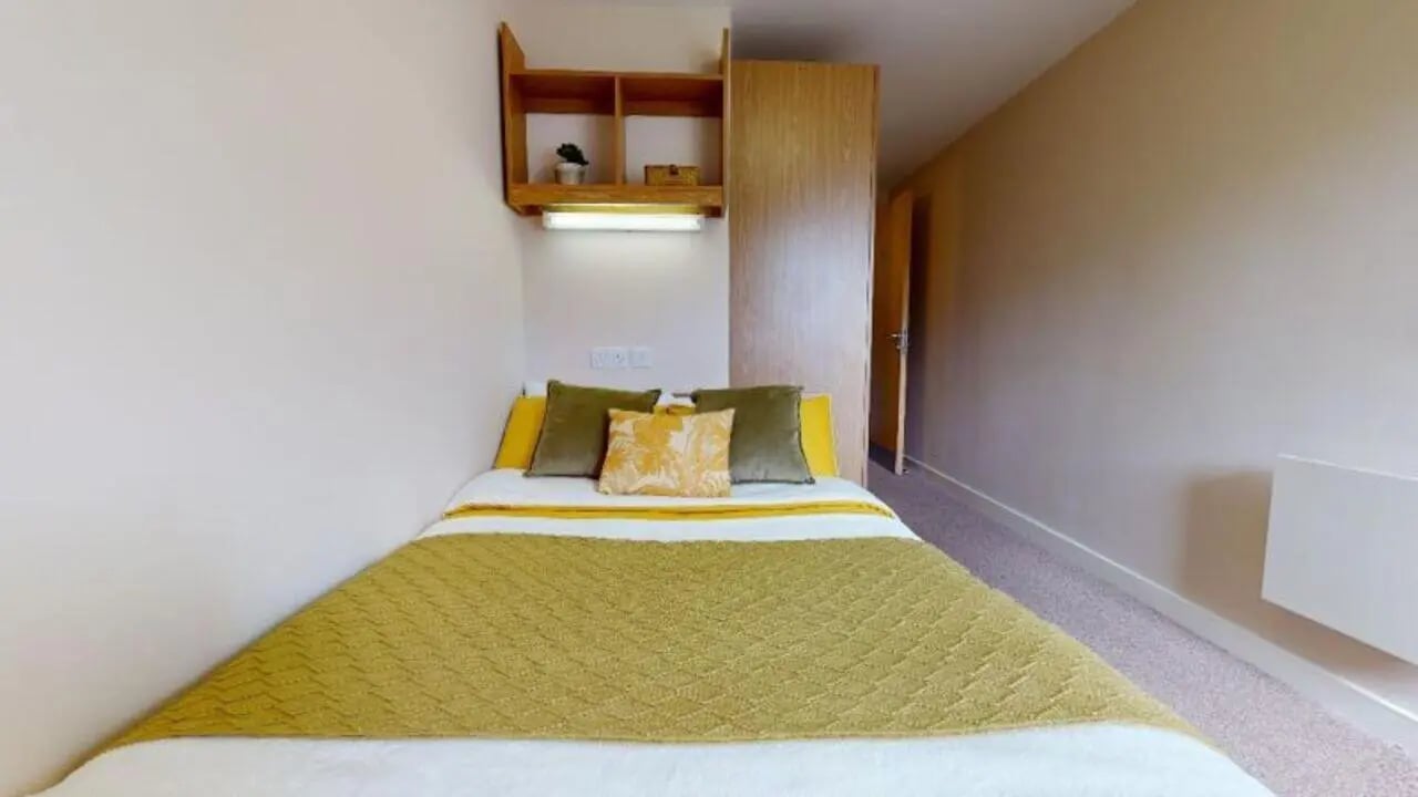 Bed pillows shelves wardrobe and heating bedroom at iQ Leeds in Leeds Student Accommodation