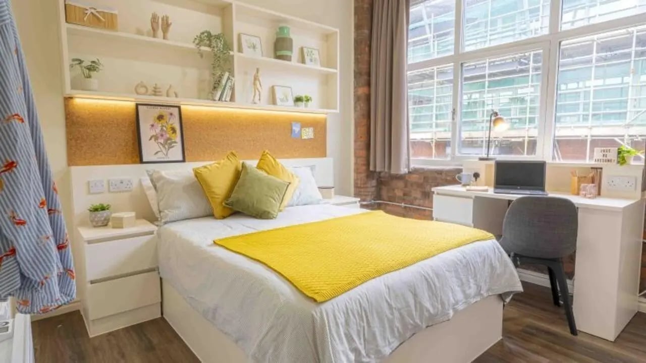 Bed nightstands desk laptop and chair bedroom at iQ Fletcher House in Manchester Student Accommodation