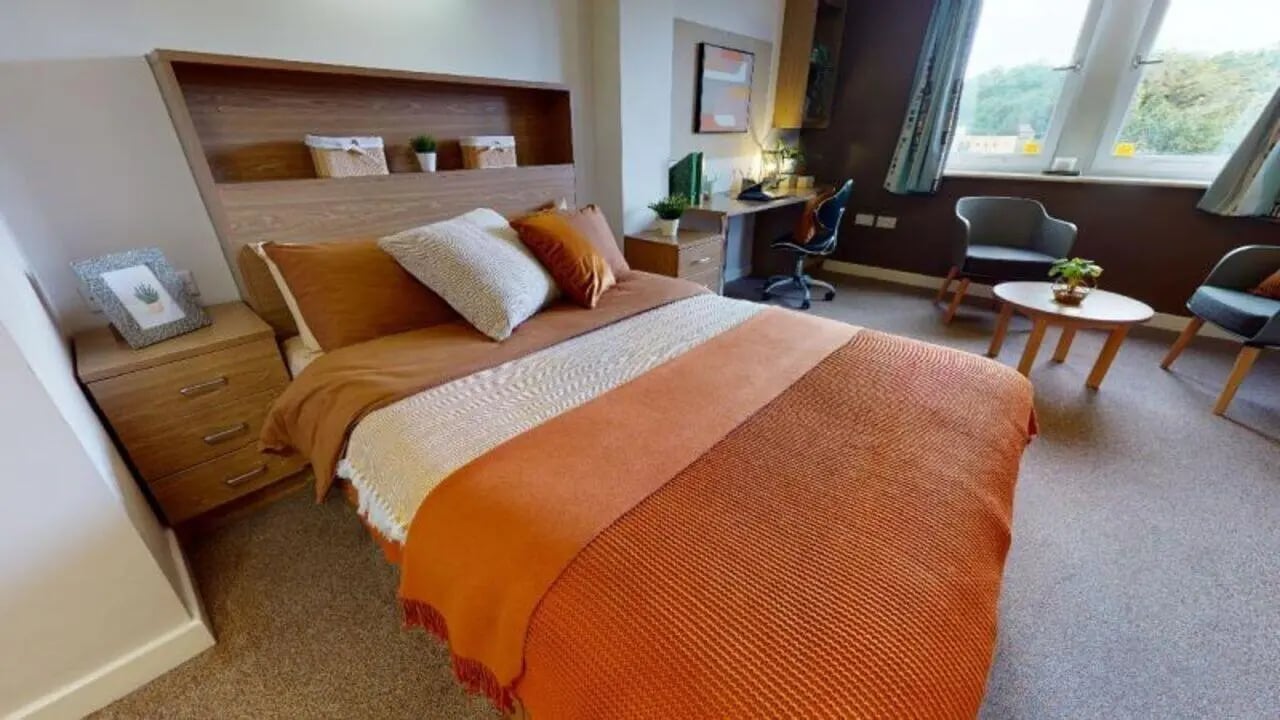 Bed study area with desk and chairs bedroom at iQ Leeds in Leeds Student Accommodation