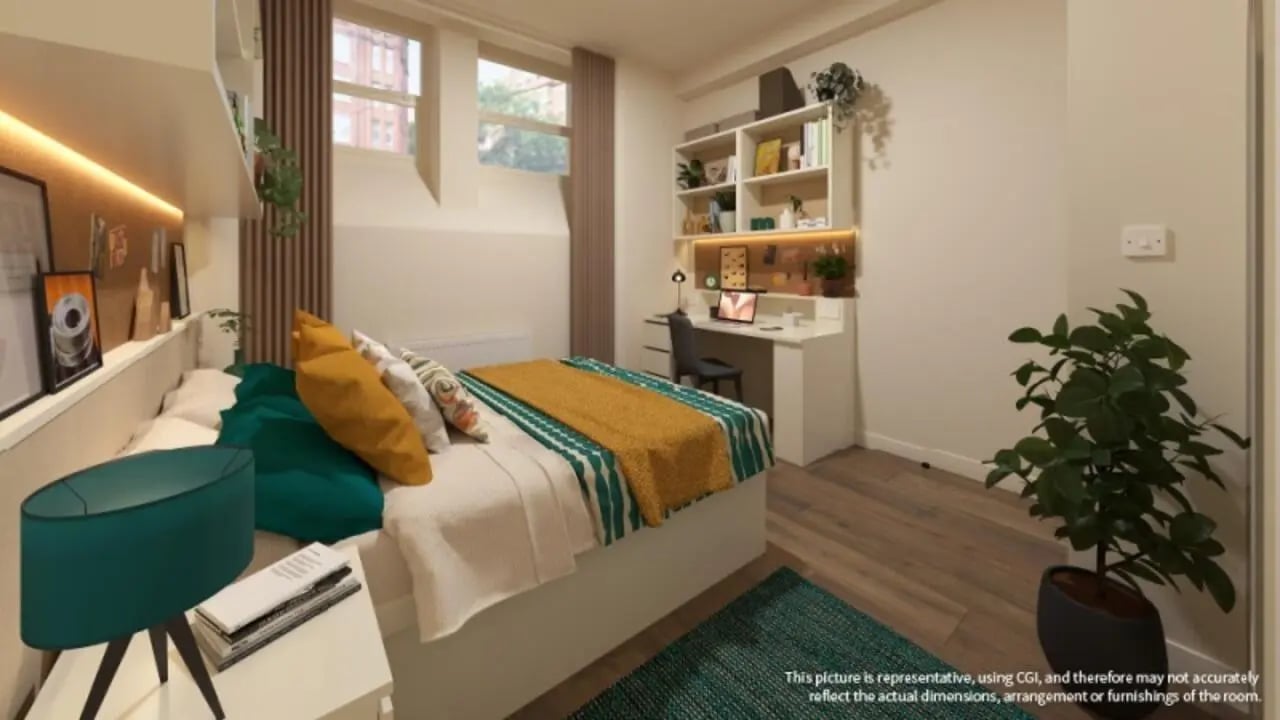 Bed desk shelves plants bedding bedroom at iQ Hollingworth House in Manchester Student Accommodation
