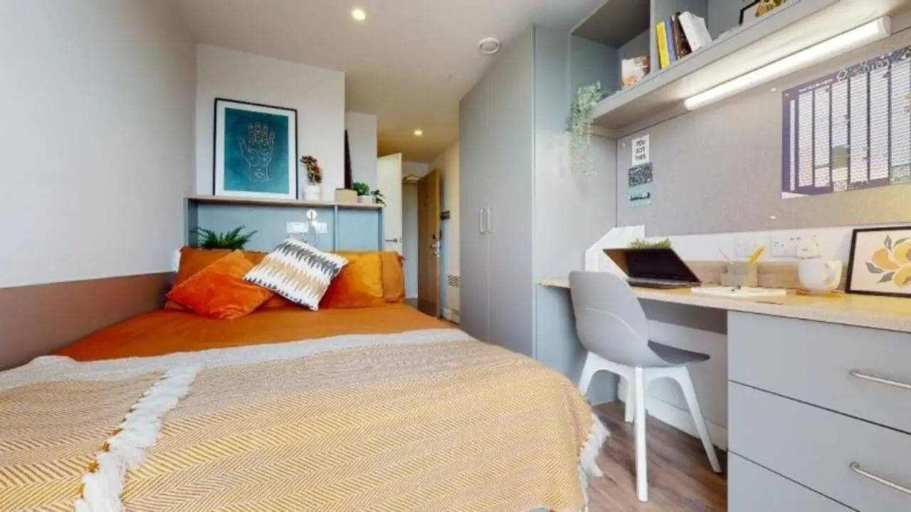 Orange bed desk and wardrobe student bedroom at iQ Weaver Place in Coventry Student Accommodation