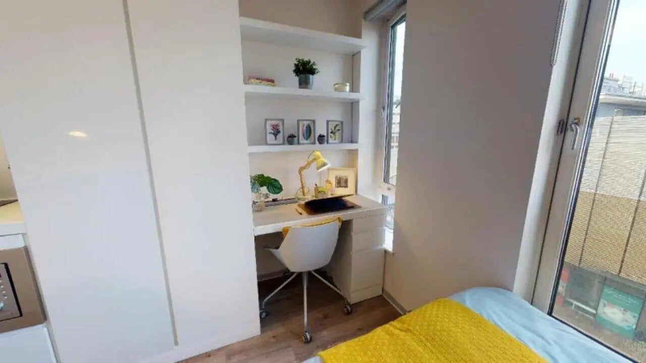 Desk with lamp and shelves bedroom at iQ East Court in London Student Accommodation