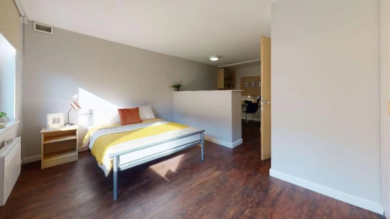 Bed with pillows and bedside table desk and chair bedroom at iQ Grosvenor House in Leicester Student Accommodation