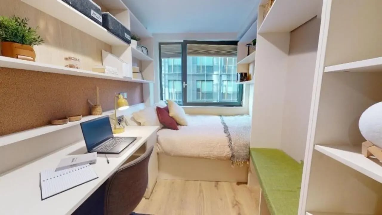 Bed desk chair shelves window bedroom at iQ Paris Gardens in London Student Accommodation