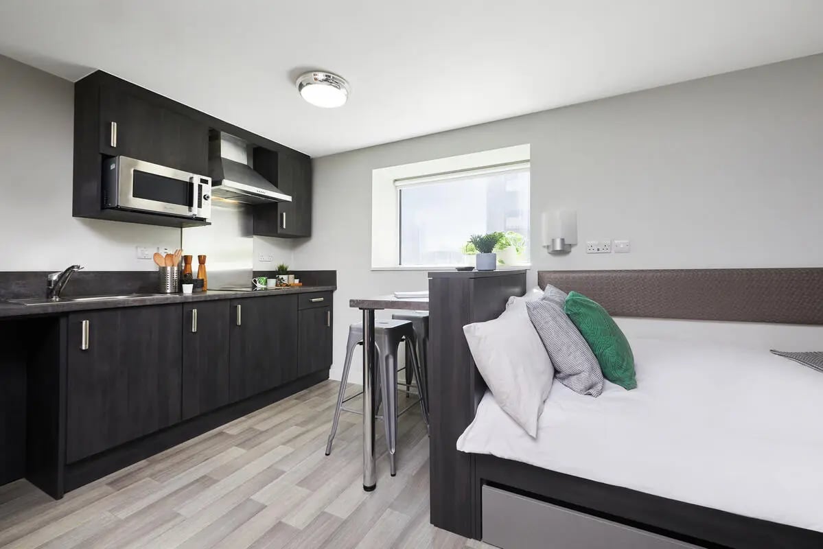 Studio apartment with kitchen and bed. at Collegiate Tower in Bristol Student Accommodation