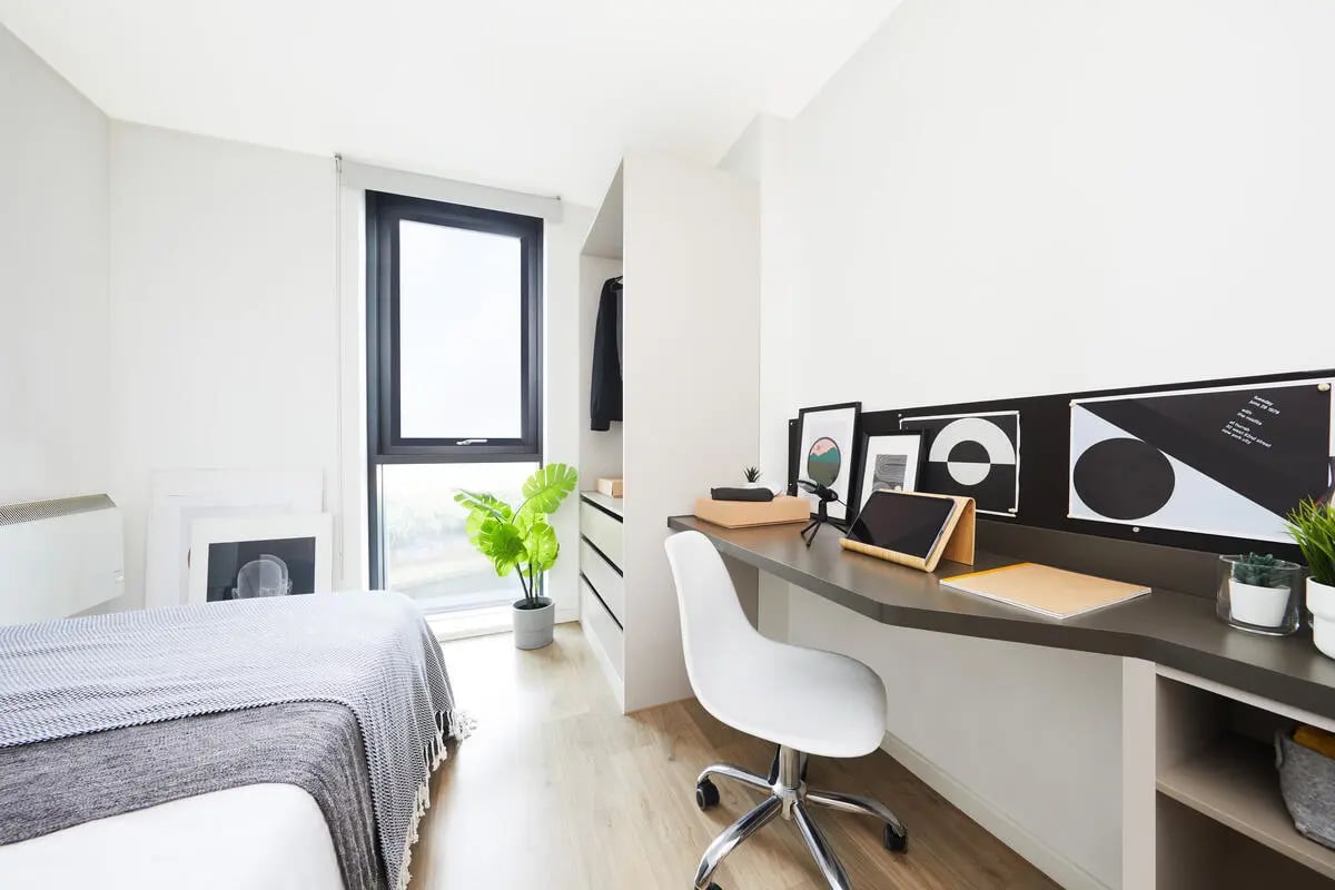Bed desk plant window and wardrobe study area at Collegiate Bagot Street in Birmingham Student Accommodation
