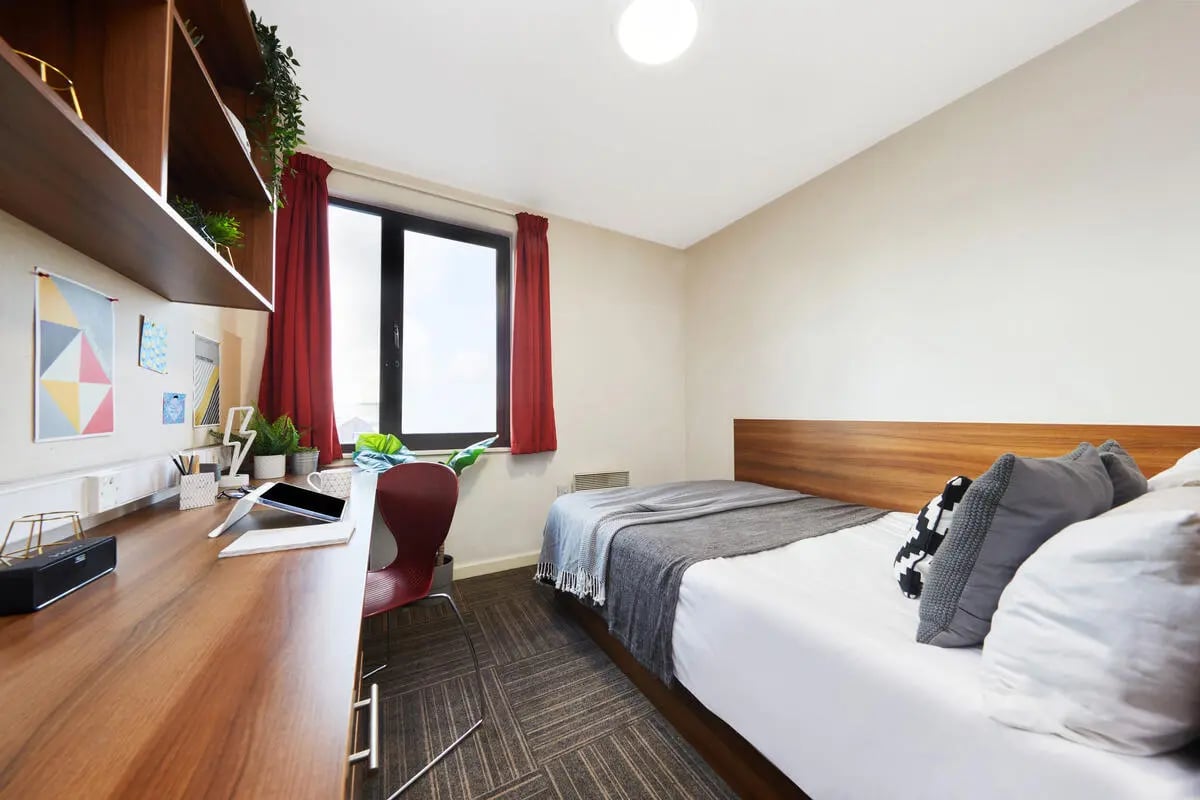 Desk with tablet plant and bed bedroom at Collegiate Bagot Street in Birmingham Student Accommodation