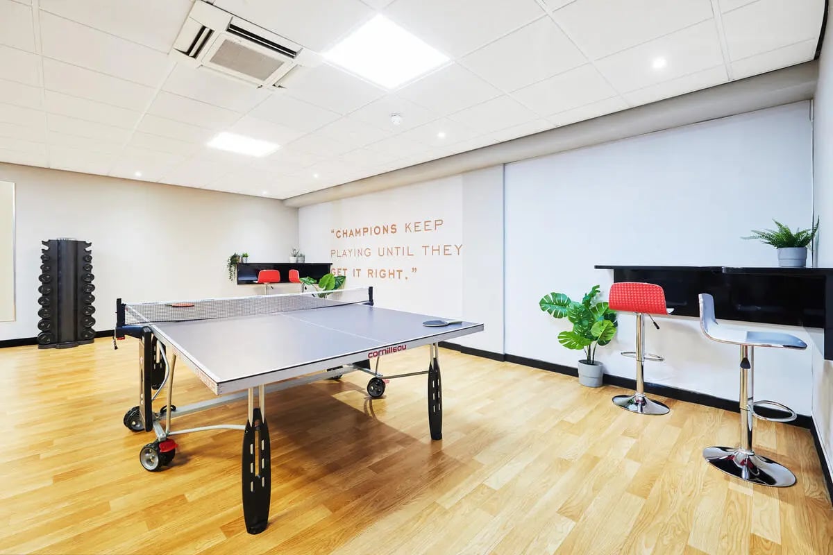 Ping pong table dumbbell rack bar stools recreation area at Burges House in Coventry Student Accommodation