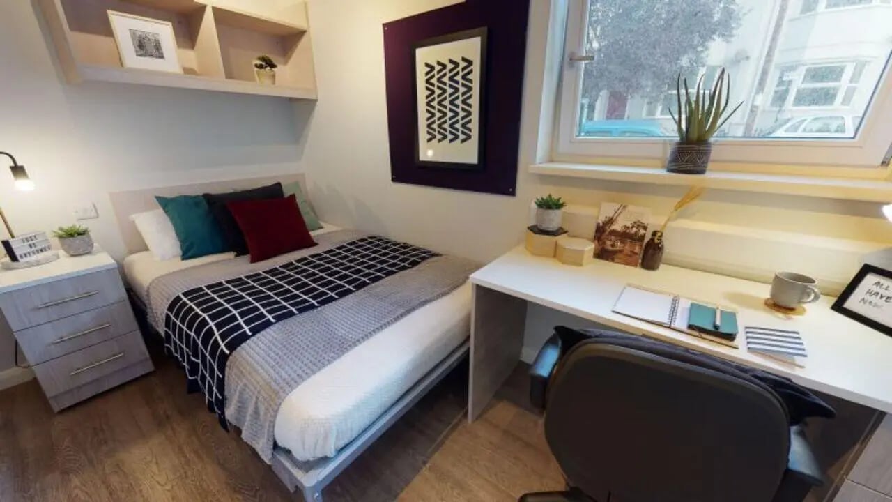 Bed desk pillows and shelves bedroom at iQ Sawmills in Brighton Student Accommodation