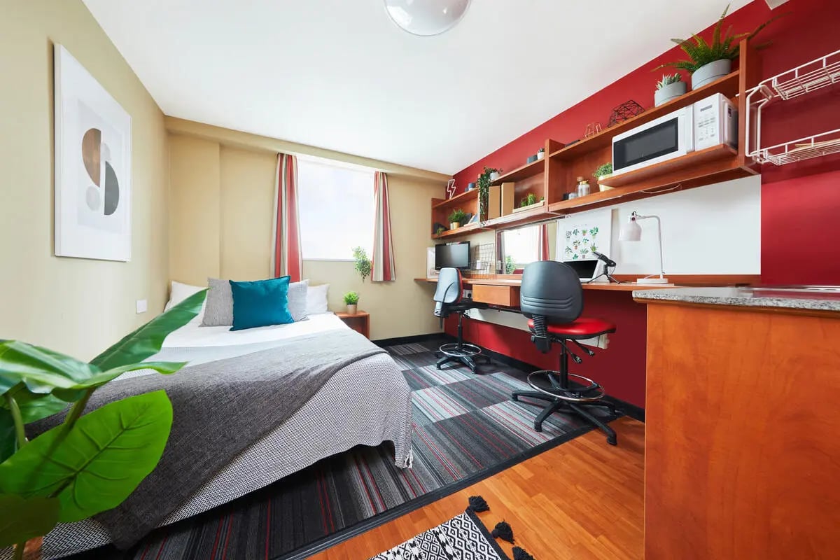 Bed desk chairs microwave shelving unit bedroom at Market Way in Coventry Student Accommodation