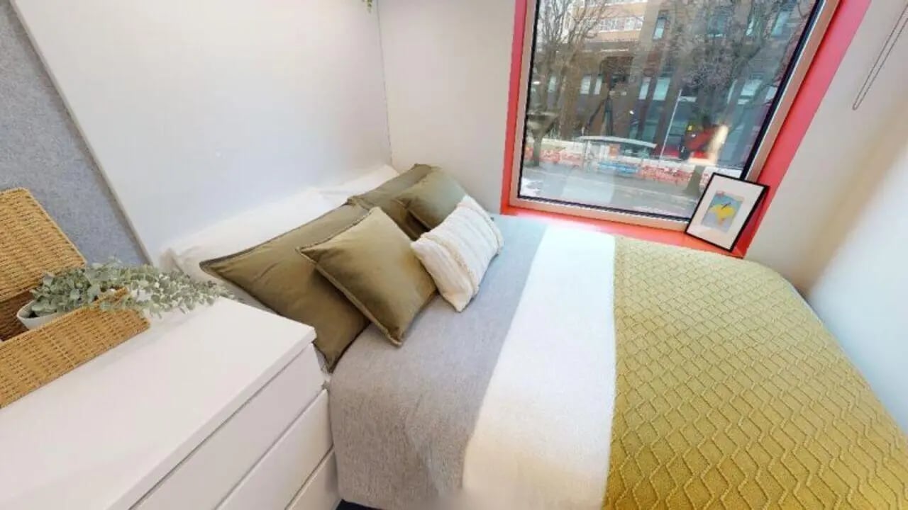 Bed with pillows and desk beside window bedroom at iQ Brighton in Brighton Student Accommodation