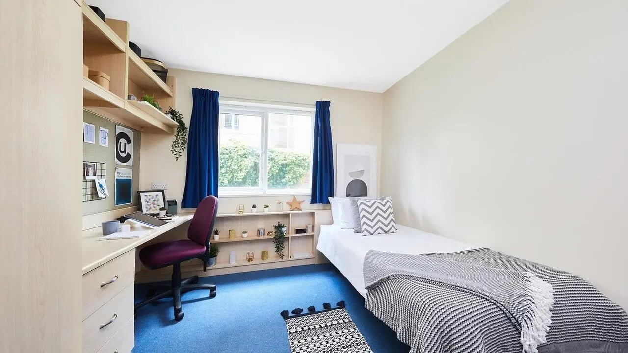 Bed desk chair shelving window bedroom at Collegiate Shaftesbury Hall in Cheltenham Student Accommodation