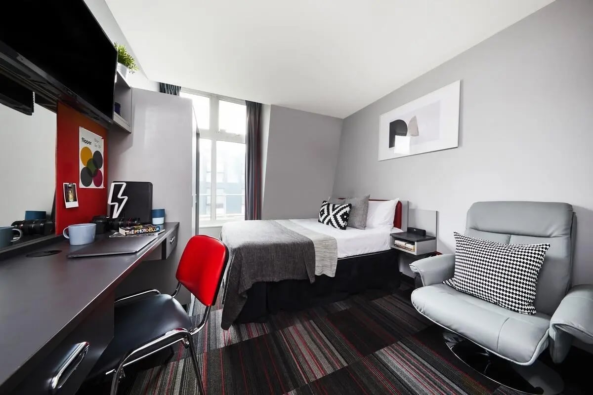 Bed desk chair and armchair bedroom at Pillar Box in Coventry Student Accommodation