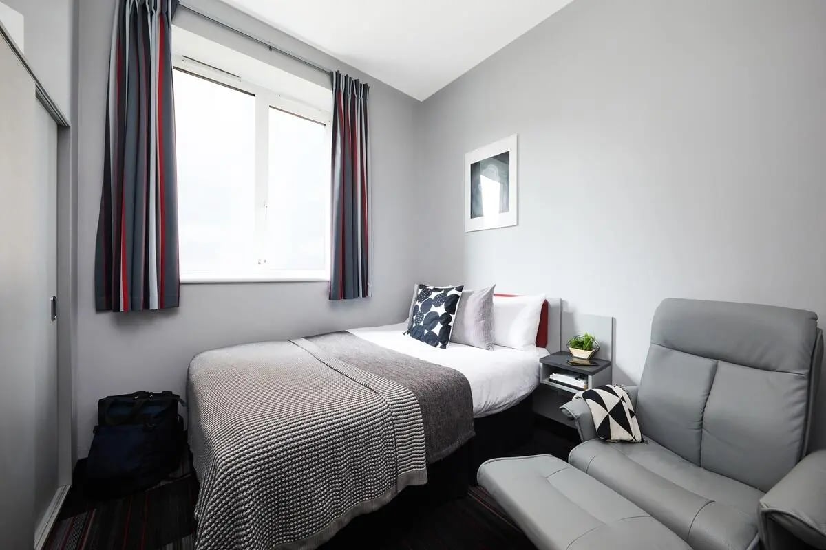 Bed luggage chair framed art bedroom at Pillar Box in Coventry Student Accommodation