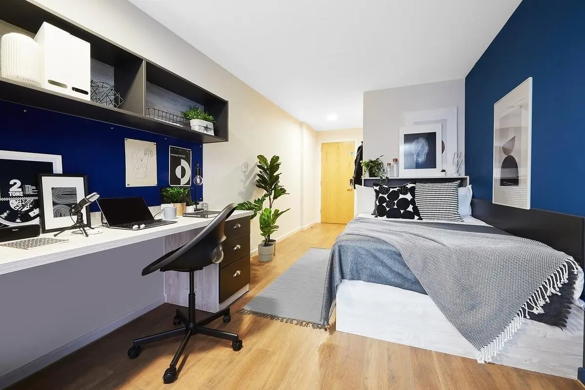 Desk laptop plant and bed bedroom at Tudor Place in Chester Student Accommodation