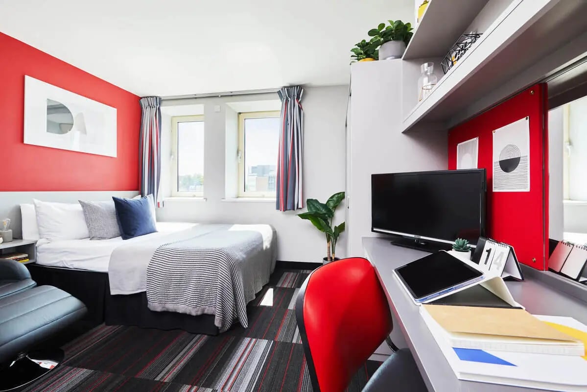 Bed desk plant and television bedroom at Corporation Village in Coventry Student Accommodation