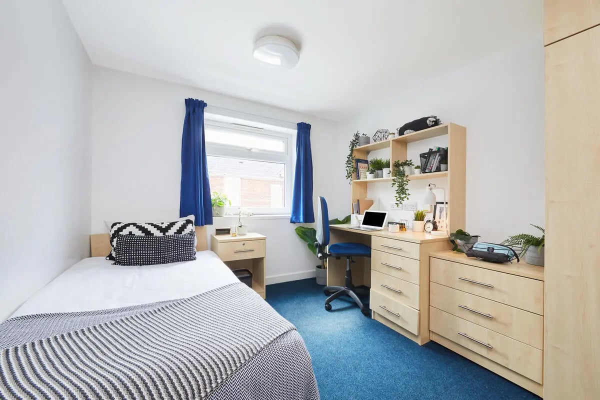 Bed desk chair shelving plants Bedroom at Collegiate Bonhay House in Exeter Student Accommodation