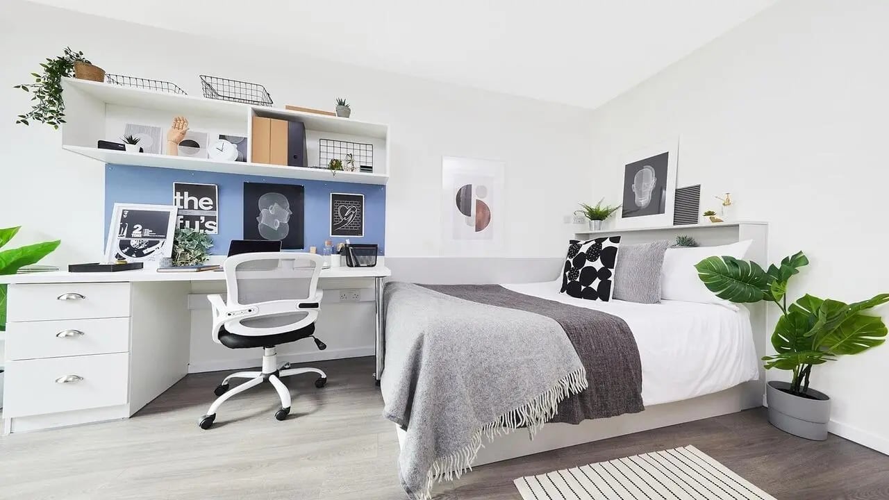 Bed desk chair shelving plants bedroom at Granary Studios in Chester Student Accommodation