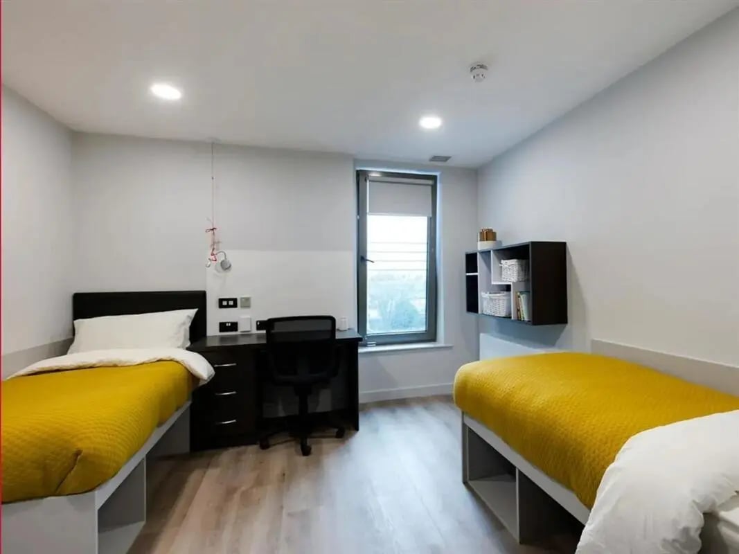 Two beds desk chair and shelves Bedroom at Brickworks in Dublin Student Accommodation