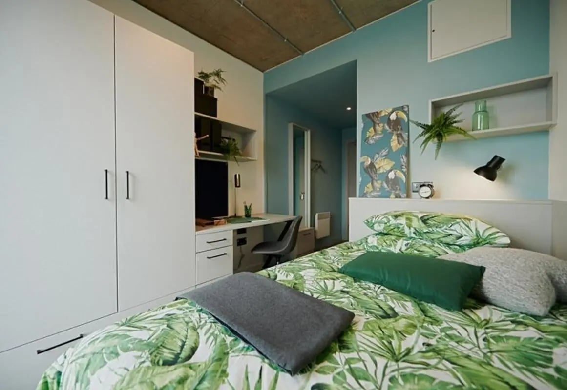 Bed study desk wardrobe tropical bedding bedroom at The Loom in Dublin Student Accommodation