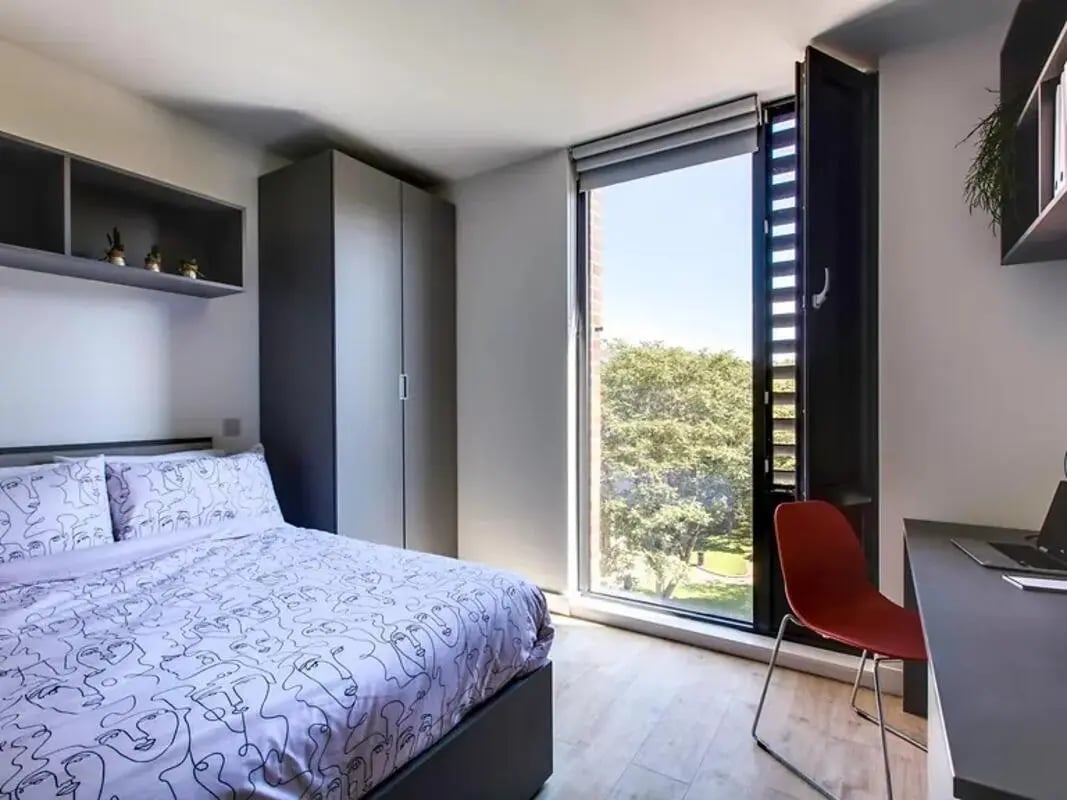 Bed wardrobe desk chair window view bedroom at Lee Point in Cork Student Accommodation