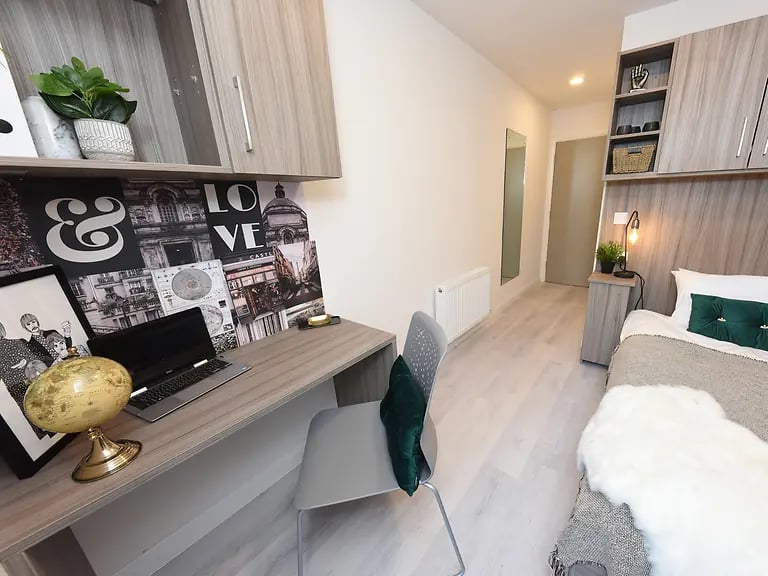 Desk globe laptop chair bed and wardrobe bedroom at Melbourn Point in Cork Student Accommodation