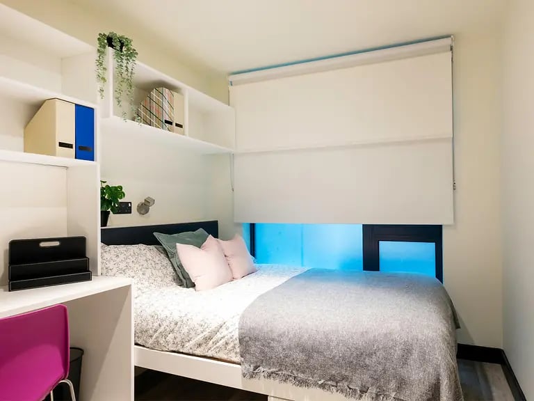 Bed with pink pillows and grey blanket bedroom at Brewers Close in Dublin Student Accommodation