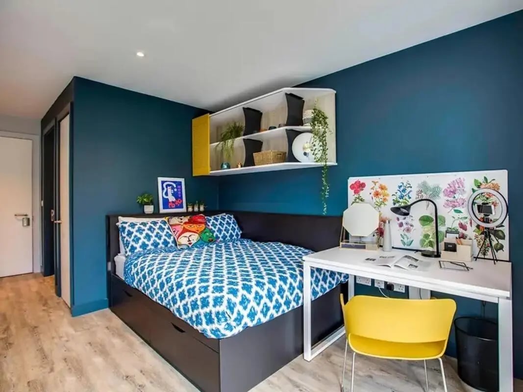 Bed with patterned bedding and desk setup bedroom at Amnis House in Cork Student Accommodation