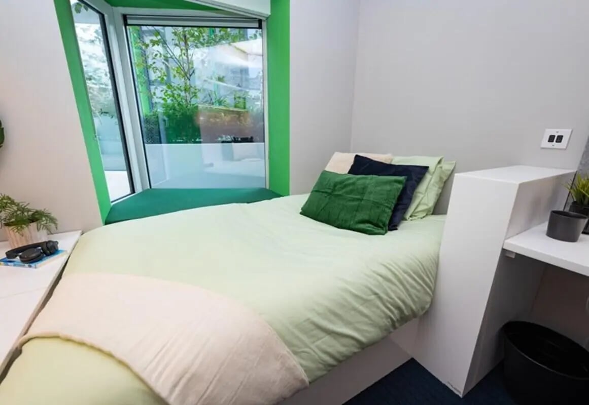Bed with green pillows large window bedroom at Stephen's Quarter in Dublin Student Accommodation