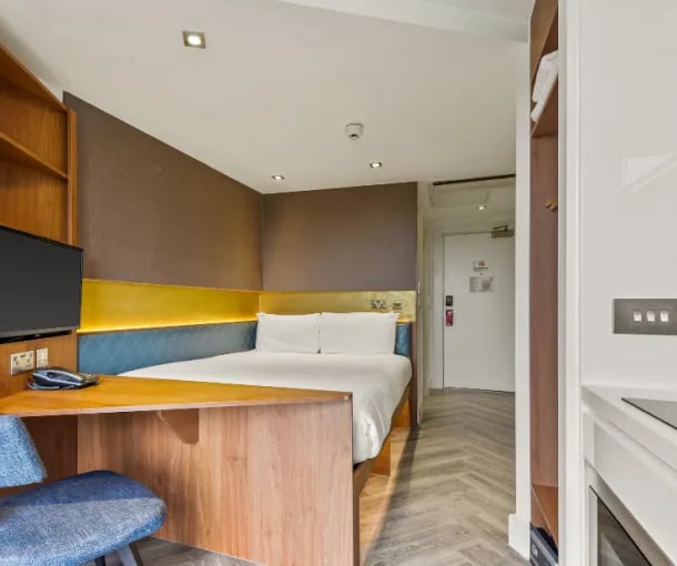 Bed desk TV and chair bedroom at IconInc London Stratford in London Student Accommodation