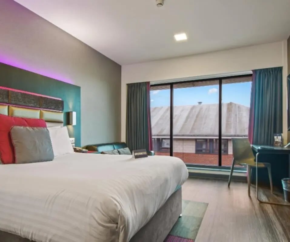 Modern bedroom with bed desk and large window Bedroom at IconInc Nottingham City in Nottingham Student Accommodation