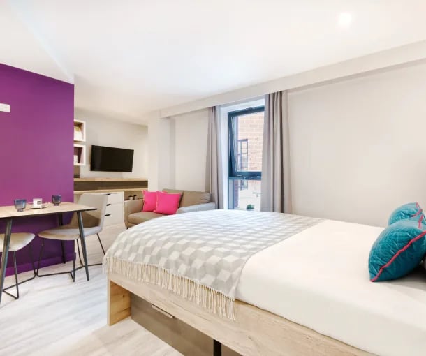 Bed sofa TV dining table with chairs studio apartment at Gravity in Lincoln Student Accommodation
