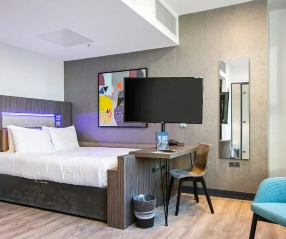 Bed desk TV chair and trash bin bedroom at Manchester Victoria in Manchester Student Accommodation