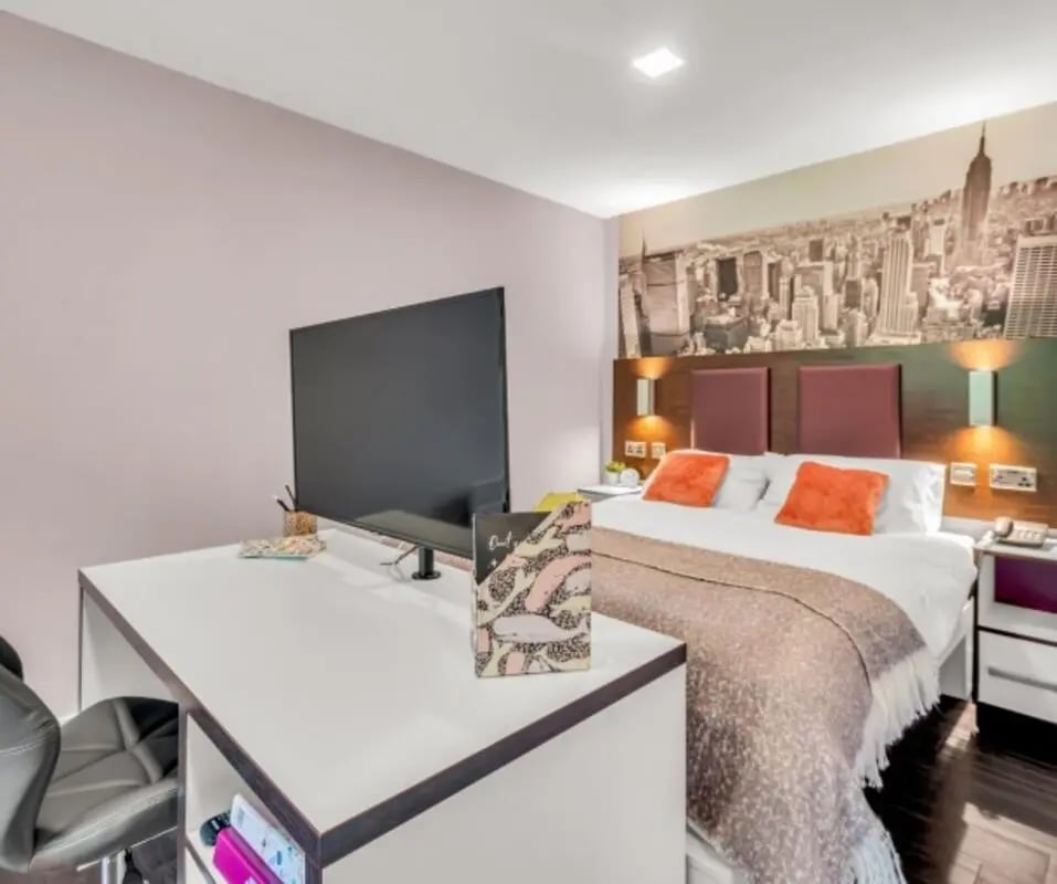 Bed desk TV and New York mural bedroom at The Edge - Leeds in Leeds Student Accommodation