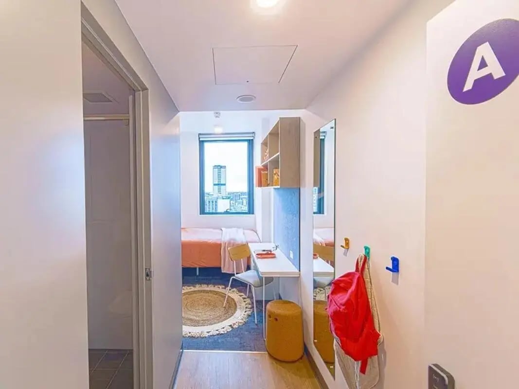 Bed desk stool mirror backpack interior at Yugo Adelaide City in Adelaide Student Accommodation