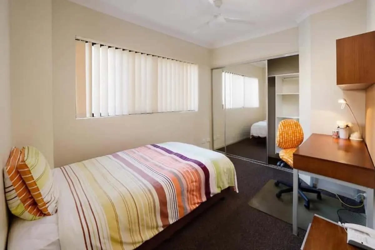 Bed desk chair mirrored wardrobe bedroom at Genesis 1 in Brisbane Student Accommodation